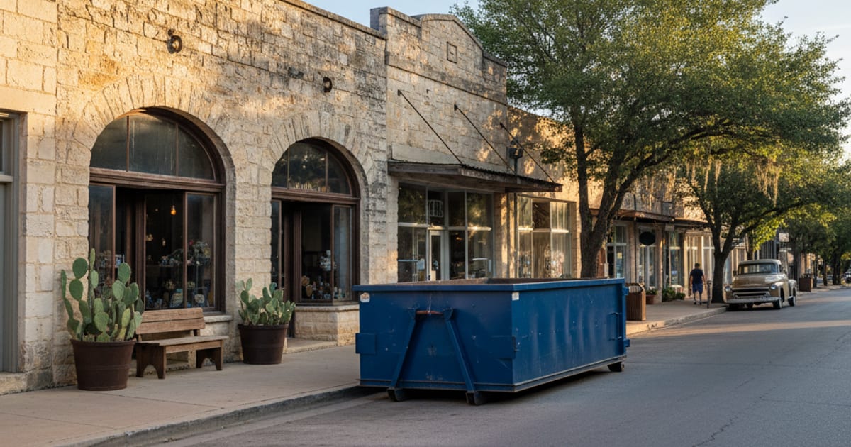Roll-off dumpster on a small Texas Hill Country town street.