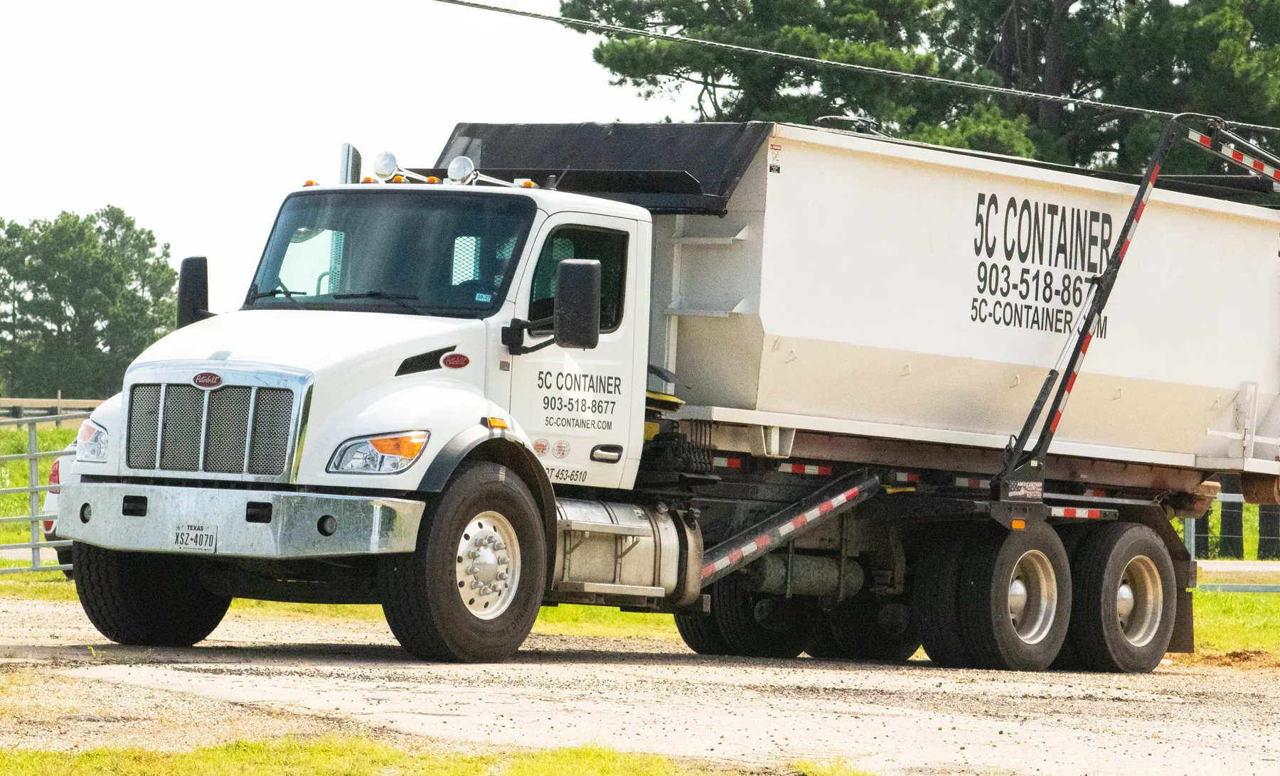 5C Container roll-off truck and white container ready for a Texas delivery